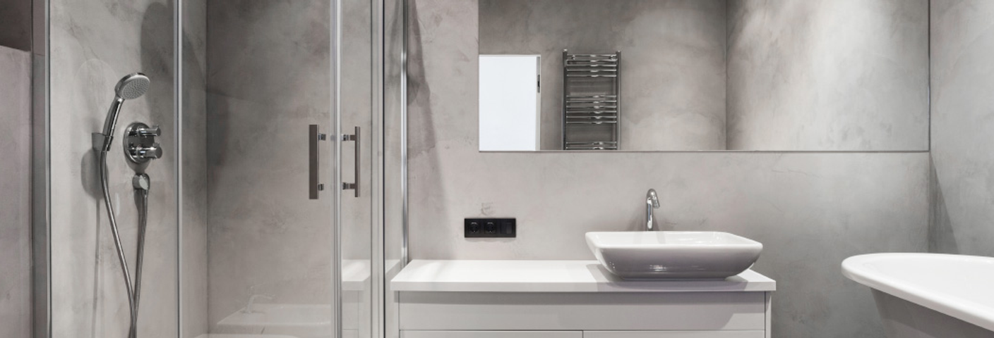Corner shower cabin in a bathroom with stone walls
